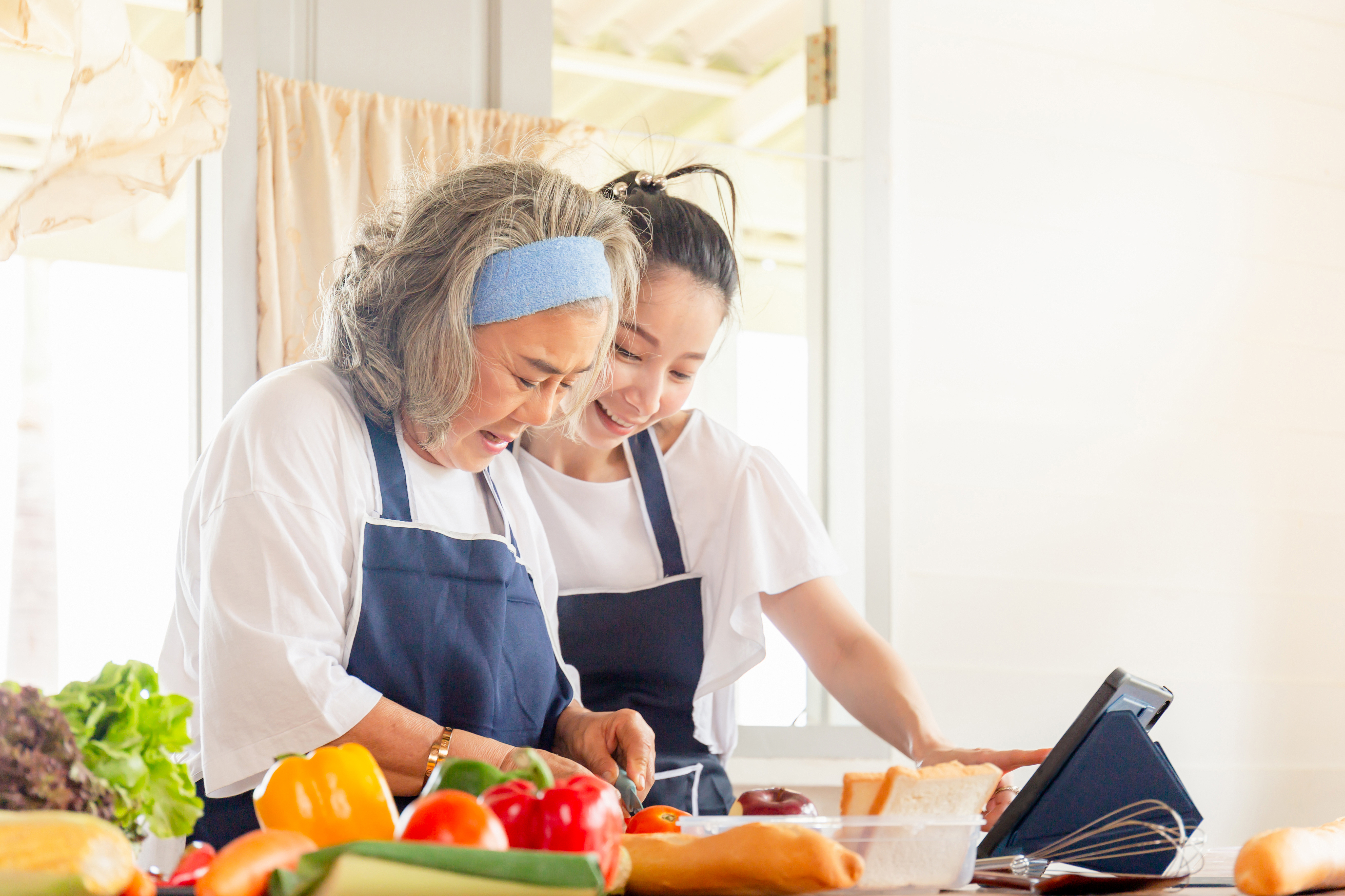 Two women having a conversation in a kitchen