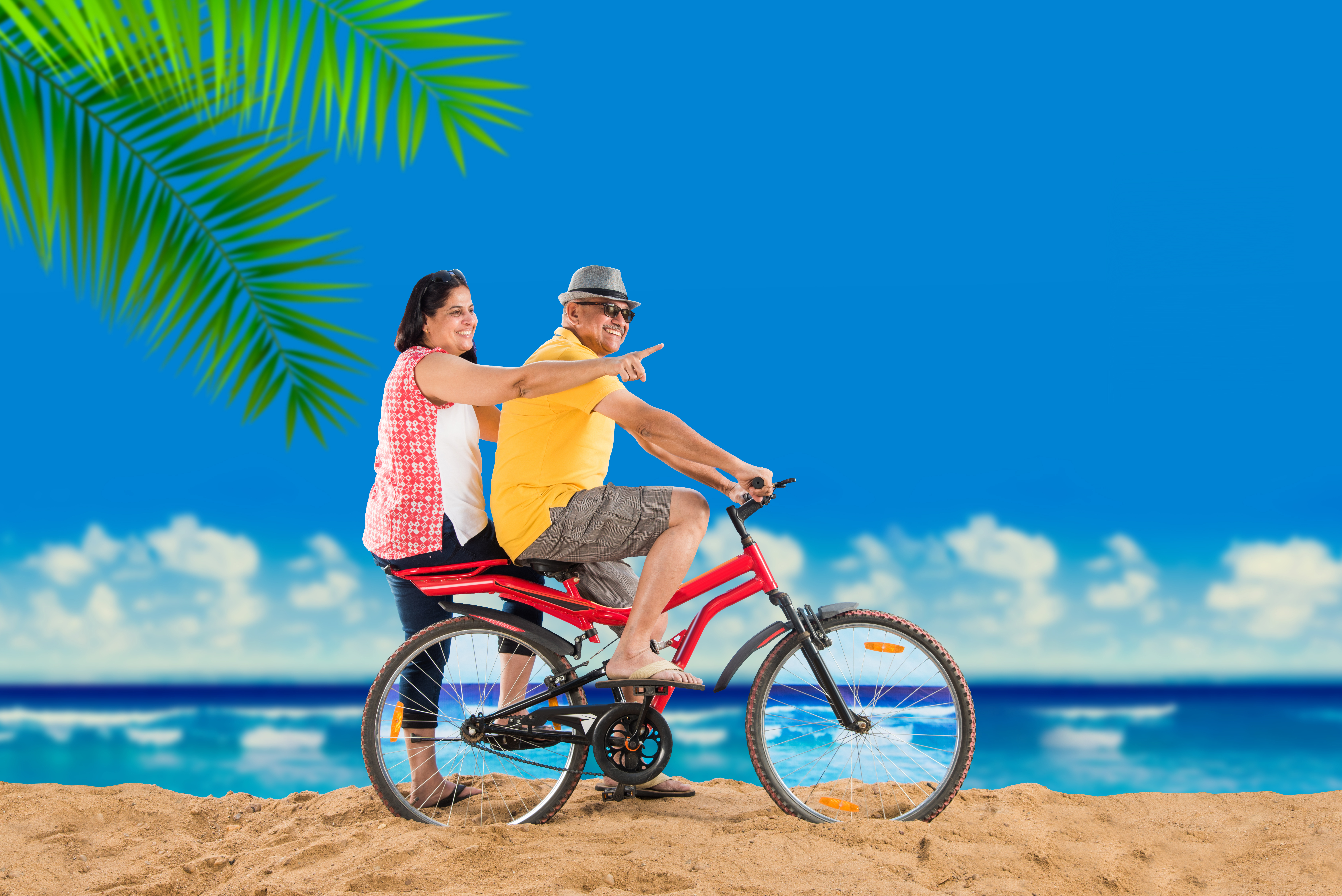 Couple with bicycle on beach