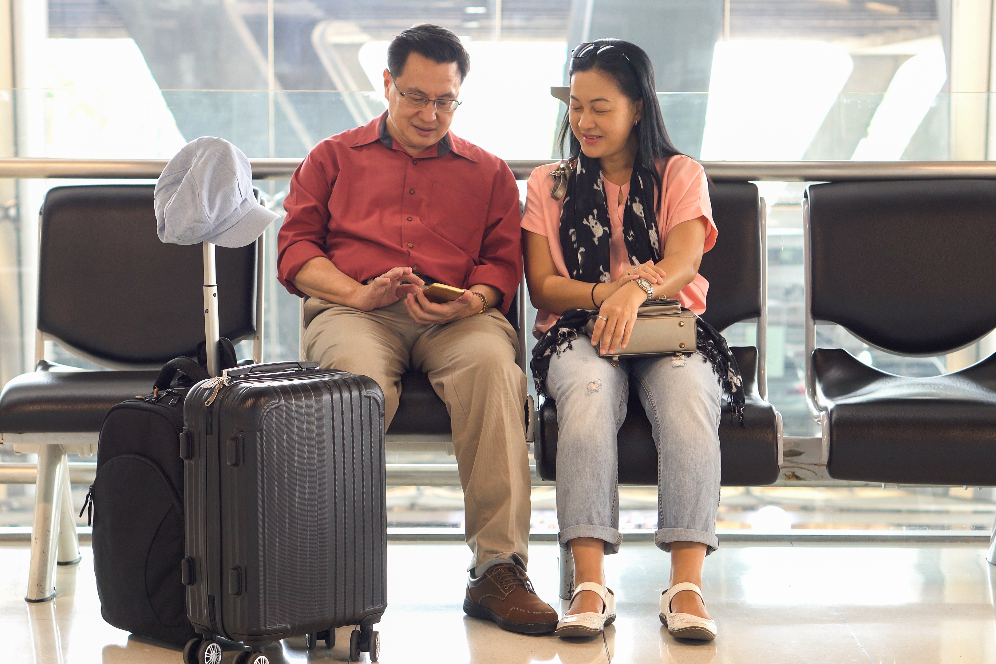 Couple with luggage waiting at airport