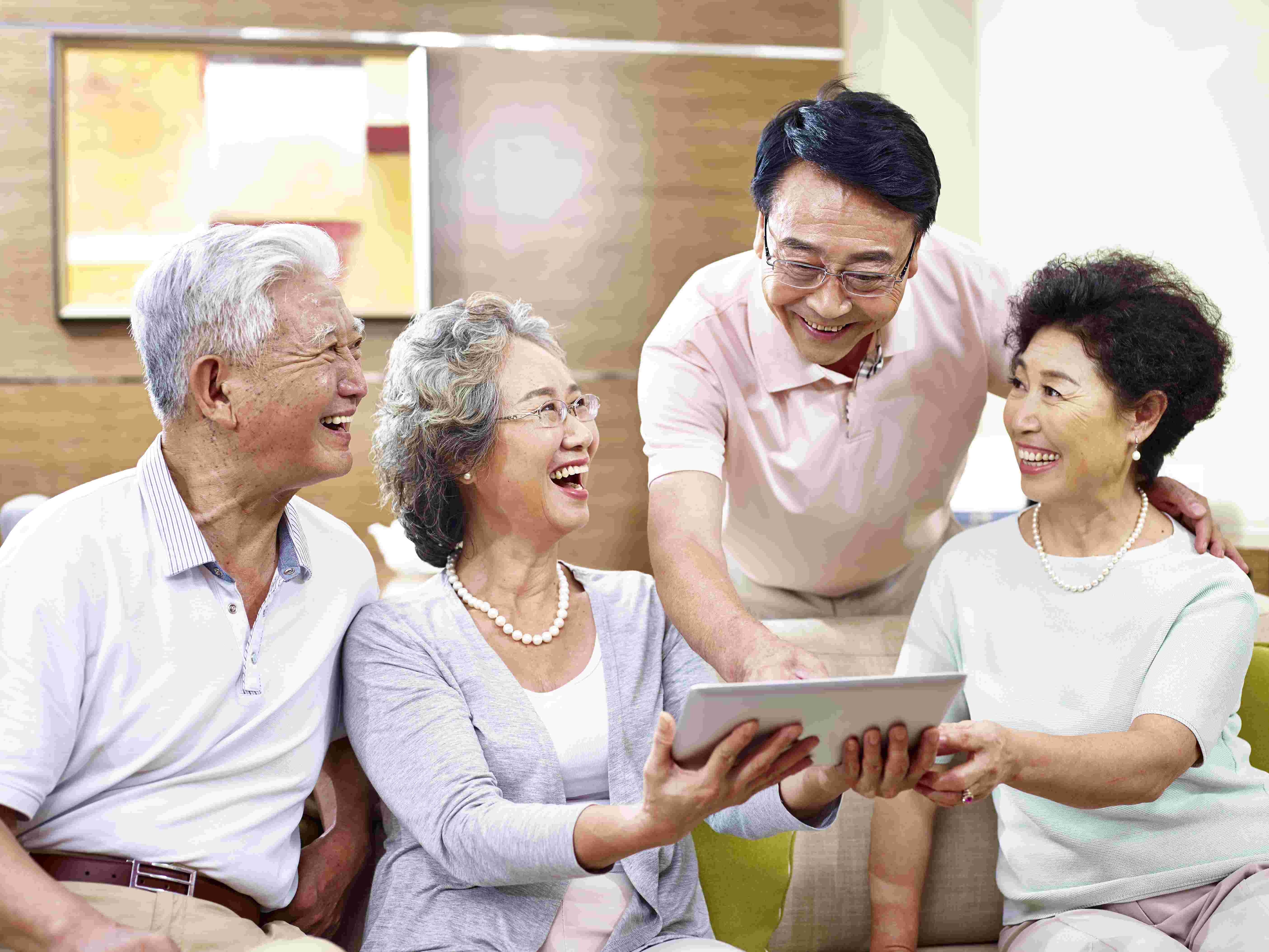 Elderly friends happily discussing social activities while on dialysis