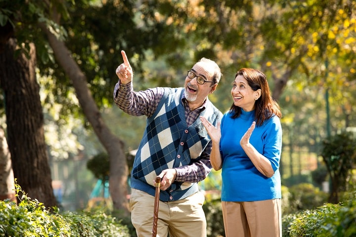 Indian couple in a park discussing about the benefits of kidney transplant