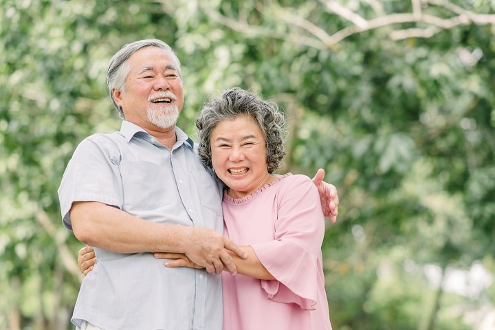 Elderly dialysis couple smiling widely