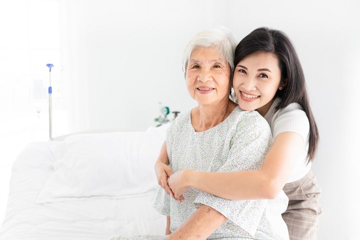 Women hugging eldery mother before preparing for dialysis