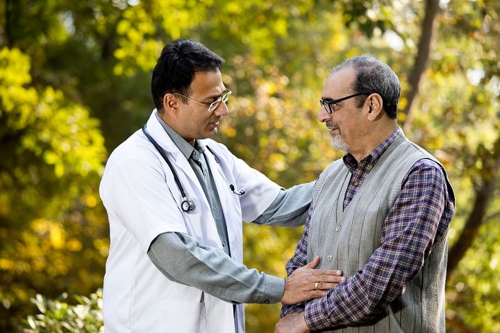 Doctor checking on dialysis patient outdoors