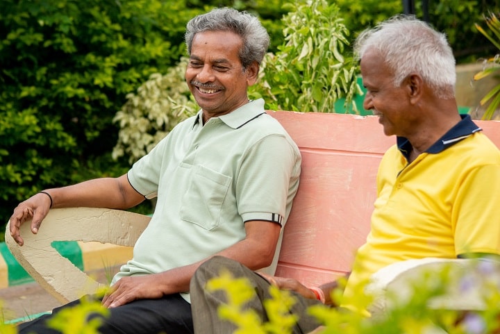 Two elderly men happily chatting about life with dialysis