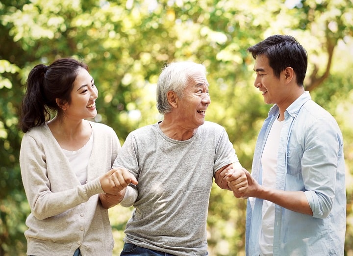 Elderly talking to young man and woman about his kidney disease