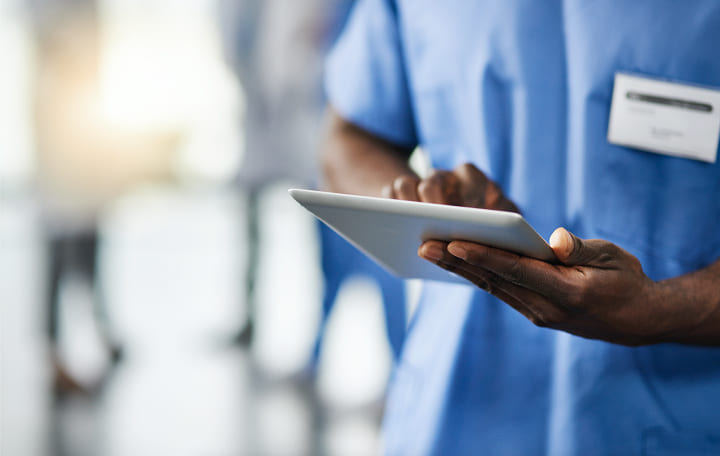 Healthcare worker holding a tablet