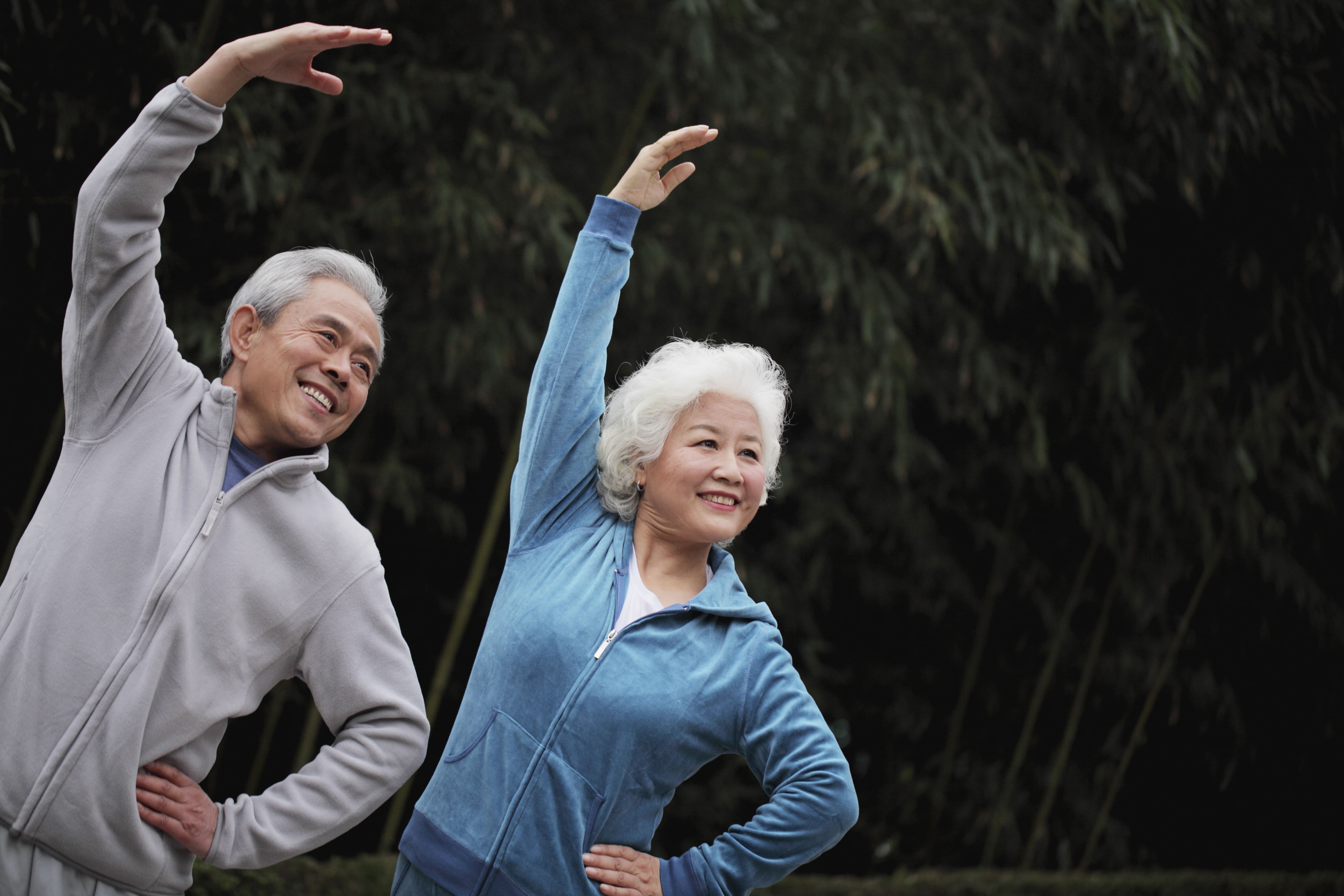 Elderly couple exercising with dialysis in the park