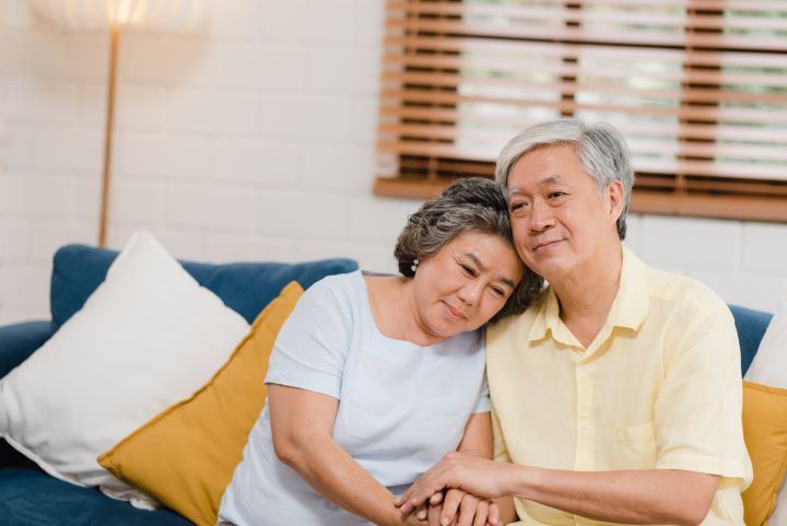 Elderly couple holding hands for emotional support about dialysis