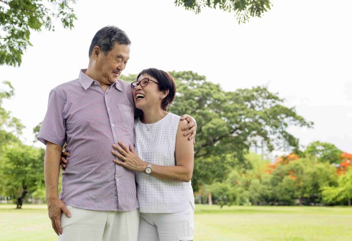 elderly man embracing wife open field dialysis