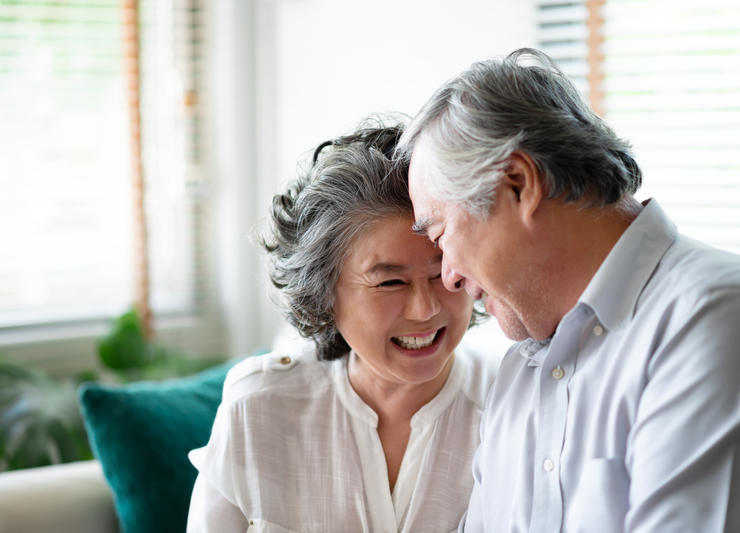 Elderly couple smiling to each other