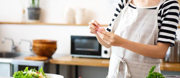 Two people preparing a salad