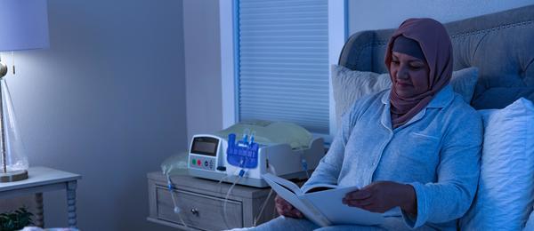 Patient reading while performing Automated Peritoneal Dialysis using a cycler
