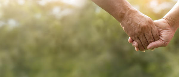Elderly couple holding hands