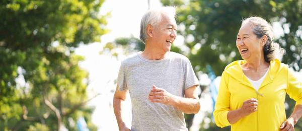 Couple with dialysis cycling on beach as exercise